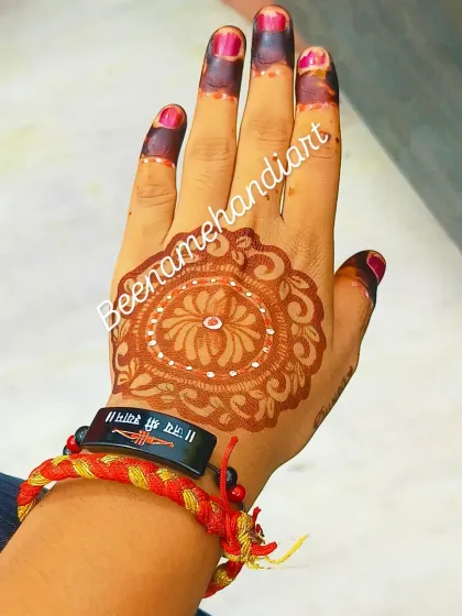 A classic mandala or gol tikki design on the back of the hand, a timeless choice for any occasion.