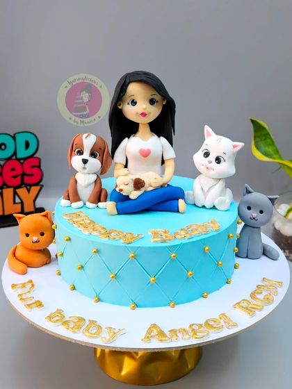 A special birthday cake for Rupali Ganguly, celebrating her immense love for fur babies with a custom figurine surrounded by cats and dogs.