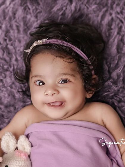 A duplicate of image 226, a fun and expressive baby portrait.