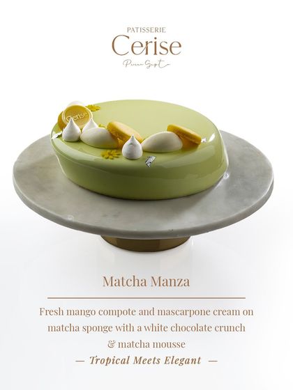 My Matcha Manza entremet sits on a beautiful marble stand. It features a fresh mango compote and mascarpone cream on a matcha sponge, with a white chocolate crunch and matcha mousse.