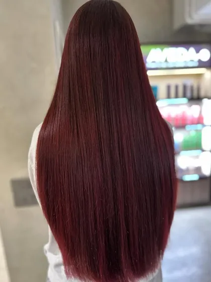 This glossy, rich red blend is a total showstopper. I used a balayage technique to melt different shades of red together, creating a vibrant, uniform color that looks incredibly shiny and healthy on long hair.