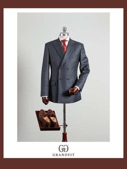 A classic grey double-breasted suit, paired with a bold red tie for a powerful contrast. This is a timeless combination for any formal setting.