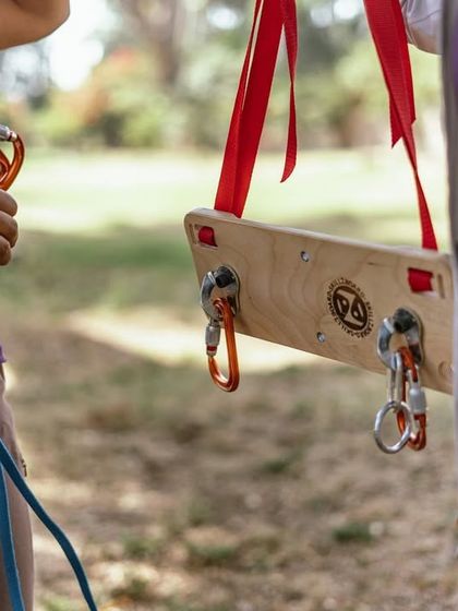 A close-up of the Skillzboard, showing how we demonstrate clipping quickdraws and managing the rope. This simple tool makes learning complex skills much more accessible.