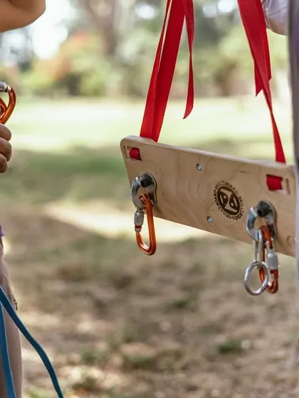 A close-up of the Skillzboard, showing how we demonstrate clipping quickdraws and managing the rope. This simple tool makes learning complex skills much more accessible.
