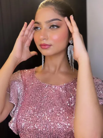 This portrait showcases the flawless skin and soft, romantic makeup that is perfect for any celebration.