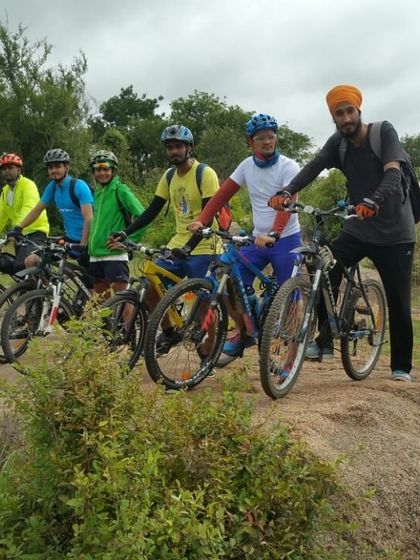 The crew posing on a rocky outcrop during a trail ride. These adventures are as much about the camaraderie as they are about the cycling.