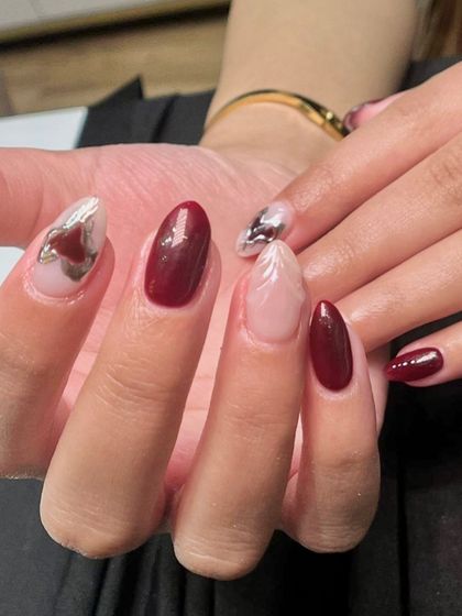 A close-up showing the detail of the sculpted, feather-like design and the abstract chrome heart.