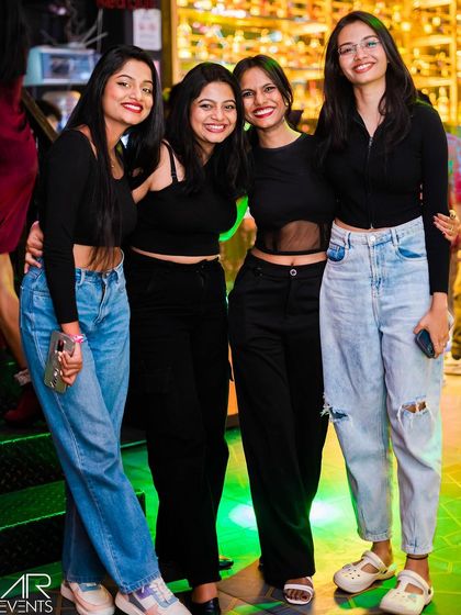 A group of friends dressed in black, looking chic and ready to party.