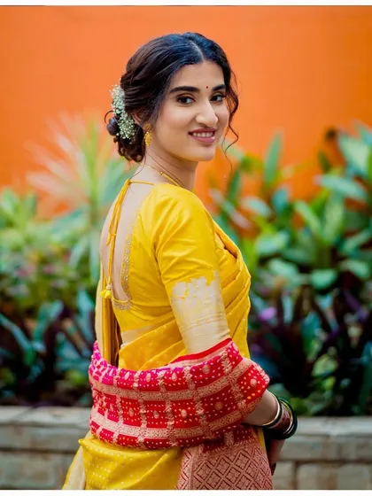 A beautiful shot of Aditi in her yellow saree for the wedding ceremony, before changing into her red lehenga for the reception. The makeup was designed to transition flawlessly.