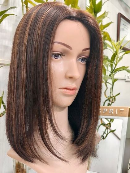 A three-quarter view of the Silk Base 5x7 Topper, showing how the hair falls naturally and frames the face.