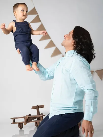 A father's love, lifting his son up high. These playful, candid moments during a family shoot often become the most cherished photographs.