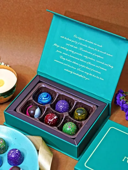 An open box of premium 'reeva' brand bonbons, showcasing both the product and its elegant packaging. This is a key shot for e-commerce, helping customers see the full gifting experience.