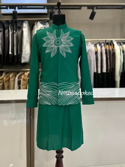 A unique green waistcoat with an abstract sun and wave embroidery design in white thread.