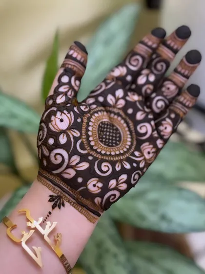 A still image of the finished cutwork design, showing the beautiful contrast and the central mandala.