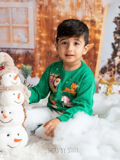 This little boy and his snowman friend are enjoying the winter wonderland setup in my studio. It's a magical scene for any child.
