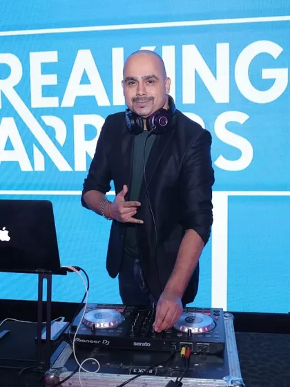 In my element at a corporate conference with the theme 'Breaking Barriers'. My job is to provide the perfect soundtrack that matches the event's energy, from walk-in music to the final party set.