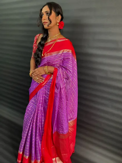 The client looking elegant with her side braid and beautiful saree. This is a classic look that never goes out of style.