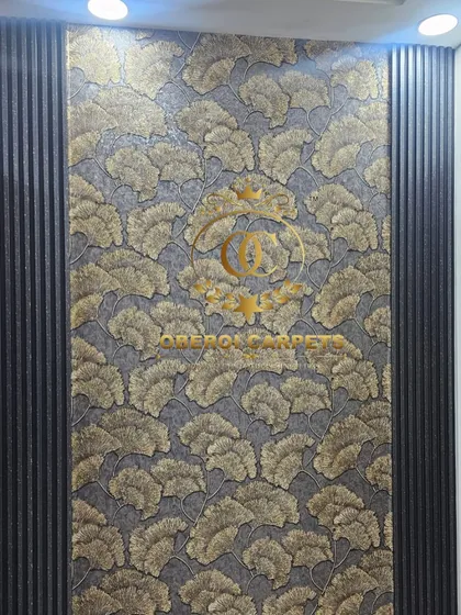 This bold, gold-leaf patterned wallpaper creates a dramatic and opulent feature wall, perfectly framed by dark fluted panels.