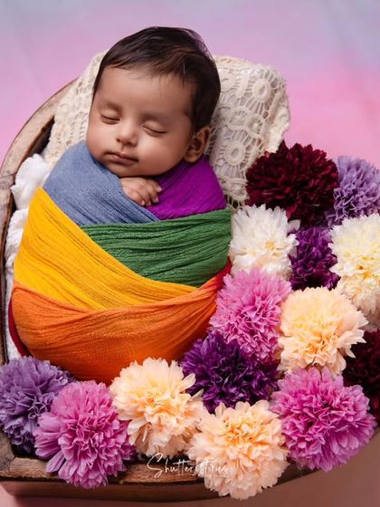 The same rainbow baby, now fast asleep, looking peaceful and content.