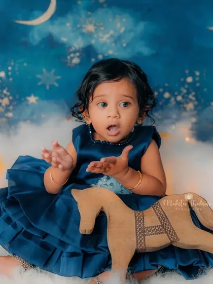 A little surprised by her rocking horse. Capturing these spontaneous reactions is what makes birthday sessions so much fun.