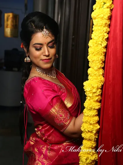 A complete look at Nirosha's engagement style. She wore a vibrant silk saree, and we created a soft glam look with a pretty pink lip and a chic updo.