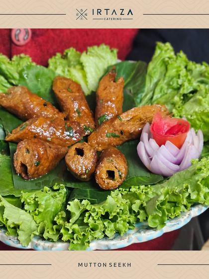 Tender and flavorful Mutton Seekh kebabs, beautifully arranged on a bed of fresh lettuce. A classic appetizer that I prepare with a special blend of spices.