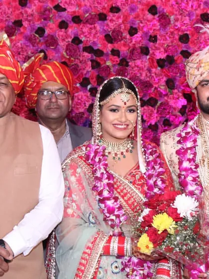 A formal portrait of the happy couple with an esteemed guest, General V. K. Singh. We ensure that we capture important moments with family and distinguished guests throughout the wedding celebration.