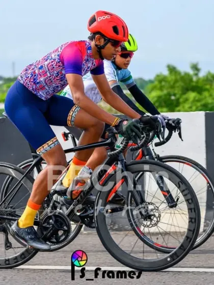 A rider in a colorful jersey stands out against the green backdrop. Our races take you through some of the most beautiful landscapes around Bangalore.