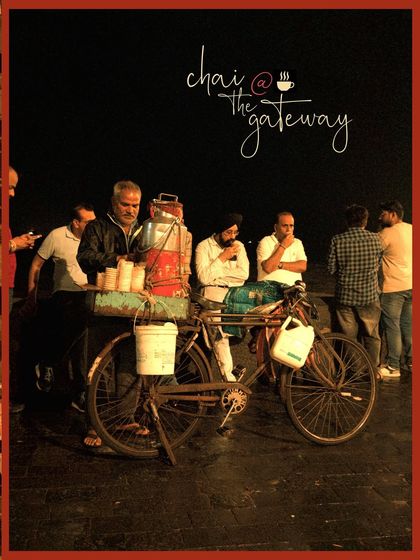Chai at the Gateway. A quintessential Mumbai night scene of people gathering around a cycle chaiwala.
