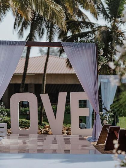 A framed view of the "LOVE" sign on the beach, showcasing how we design every angle for the perfect shot.