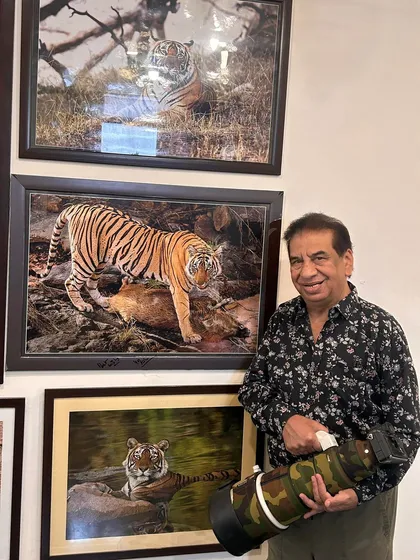 Another one of my framed photographs on display. Holding my 400mm lens next to the print shows the power of this gear to capture images worthy of being hung on a wall.
