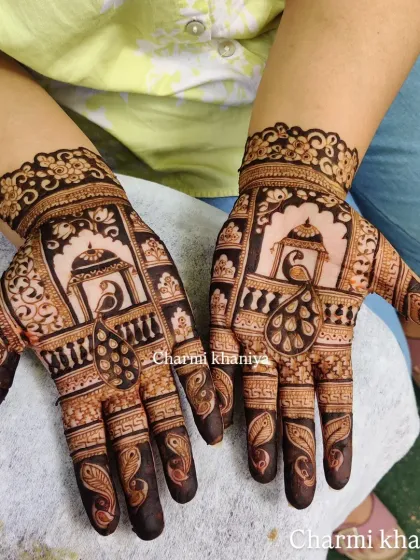 From blank hands to henna beauty. This design features peacocks resting in a 'jharokha' or window, a classic element in Rajasthani and traditional mehendi art.