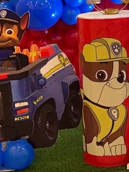 Cutouts of Chase and Rubble from Paw Patrol, placed as part of the party's main decoration setup.