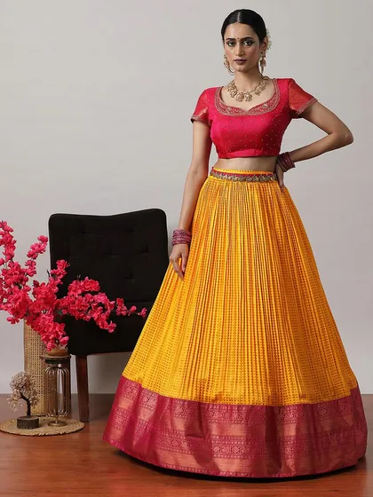 The full view of the yellow and pink lehenga without the draped dupatta, showcasing the pleated skirt and embroidered blouse.