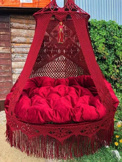 A stunning, deep red bed swing that brings a sense of passion and luxury. The tufted velvet cushion makes it incredibly comfortable and inviting.