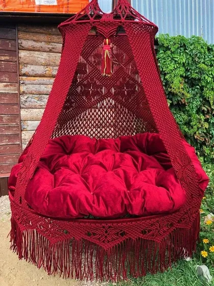 A stunning, deep red bed swing that brings a sense of passion and luxury. The tufted velvet cushion makes it incredibly comfortable and inviting.