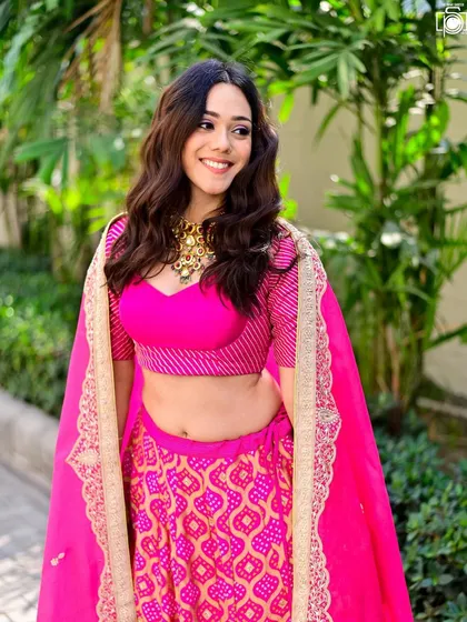 A great event is filled with beautiful portraits. I captured this guest's radiant smile and vibrant pink lehenga during a wedding celebration. My approach is to find natural, happy moments that showcase the beauty and style of the people attending.