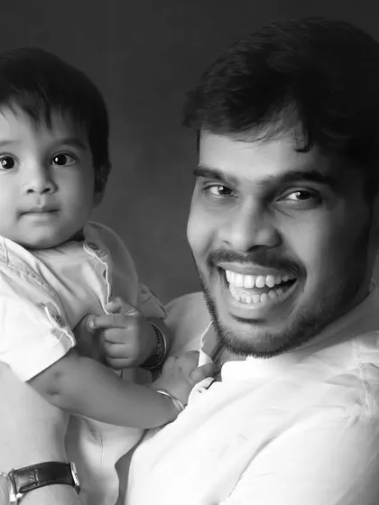 A father and son portrait that pops in black and white. The contrast highlights their bright smiles and creates a powerful, happy image.