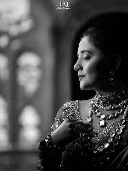 A serene black and white bridal portrait. The side profile and closed eyes convey a sense of peace and contemplation before the ceremony.