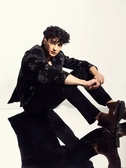 Another angle from the mirrored shoot, showcasing the clean skin finish and well-groomed hair.