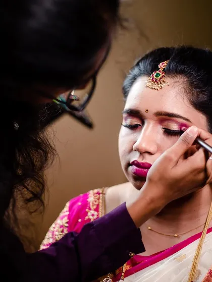 A behind the scenes glimpse into my process. Here, I am carefully applying eye makeup, focusing on blending and precision to create a look that is both striking and will last through all the emotions and events of the wedding day.
