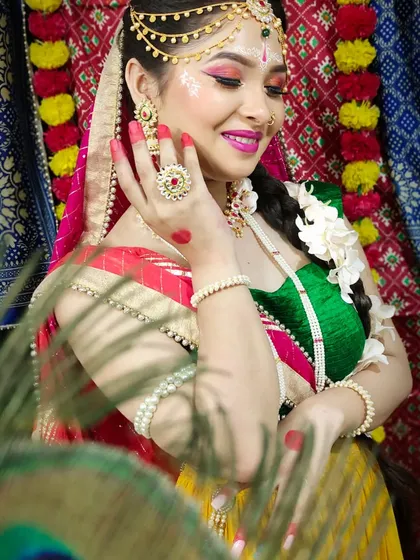 Here is a detailed look at the Radha makeup, with bright pink eyeshadow, traditional jewelry, and delicate hand art, capturing her grace and beauty.