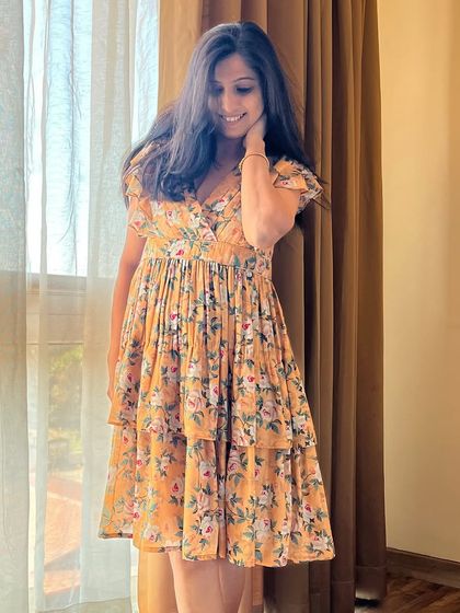 Twirl into style with this tiered floral dress. Its effortless elegance is captured perfectly in this shot.