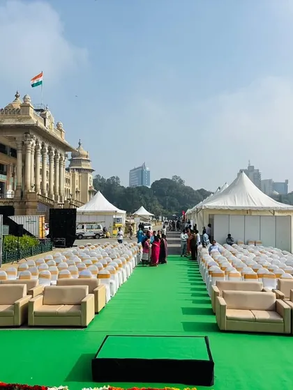 We managed the complete infrastructure for the EV Expo at the iconic Vidhan Soudha. This image captures the scale of the outdoor setup, including VIP seating, tents, and a green carpet walkway, demonstrating our ability to execute large-scale events in prominent public spaces.