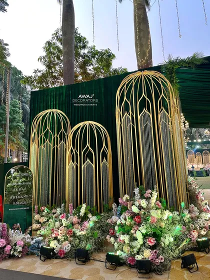 The welcome area at the entrance, with a custom sign and beautiful floral arrangements.