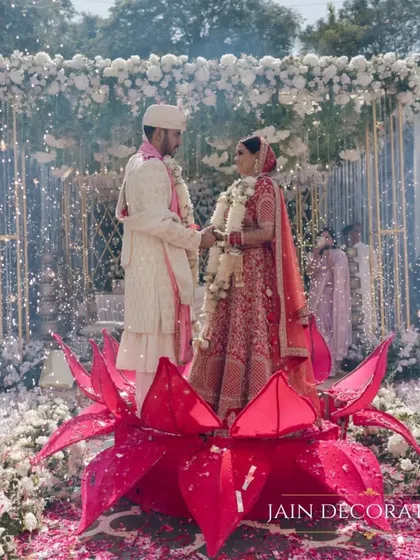 A truly iconic moment for the bride and groom. I designed this unique lotus structure for the jaimala ceremony, allowing the couple to emerge from a bloom, creating a powerful, symbolic, and absolutely magical memory.