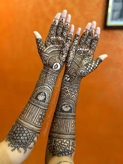 A back-of-the-hand view of a full bridal mehendi. The design features lotus and peacock motifs, creating a stunning look from every angle.