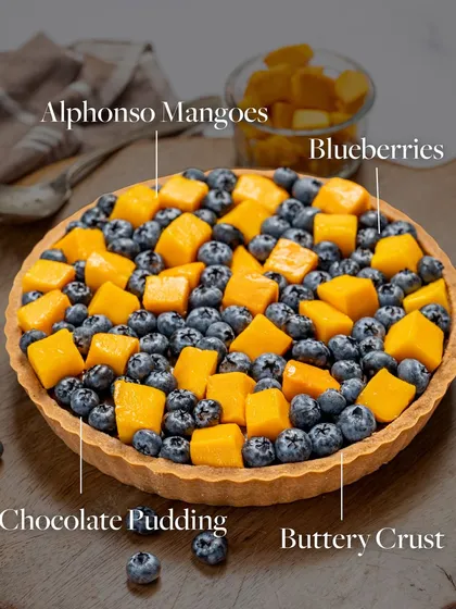 Here’s the breakdown of my Mango and Blueberry Tart. It features a buttery crust, rich chocolate pudding, and a generous topping of fresh Alphonso mangoes and blueberries.