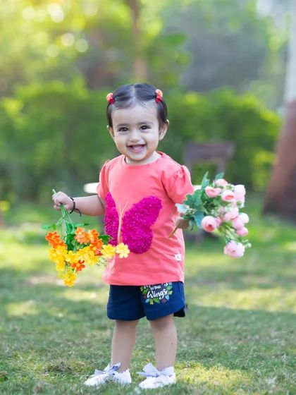 Spreading her wings with a beautiful smile. This candid shot in a sunny park captures the pure happiness and carefree spirit of childhood that I strive to preserve in my photos.