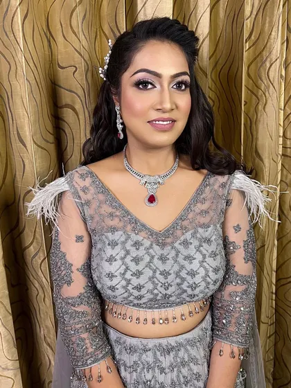 This engagement look on dusky skin proves that minimal glam always works. The grey outfit is tricky, but the soft makeup with a pop of color on the lips looks stunning.